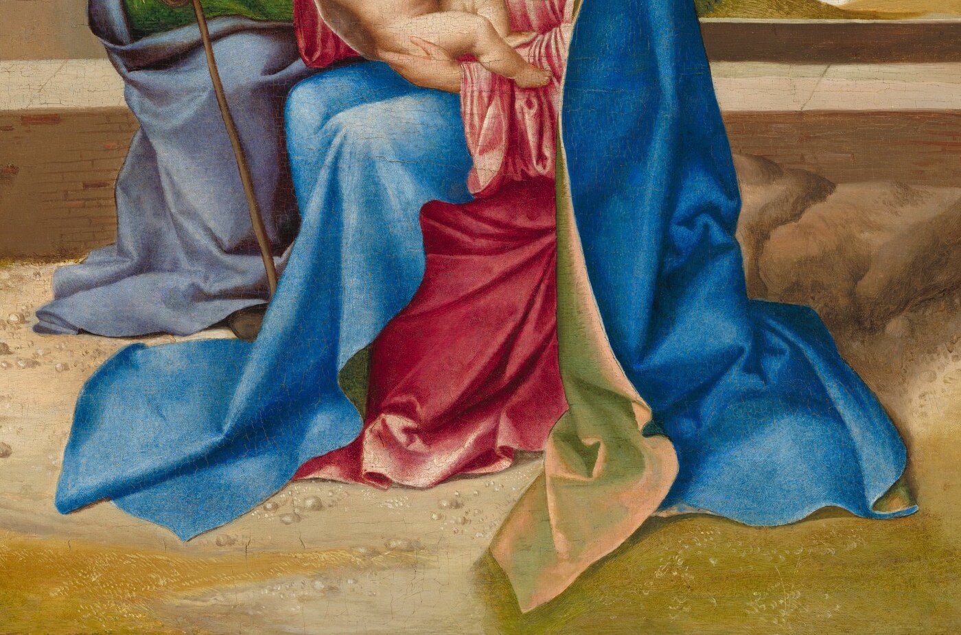 The vast blue pool stabilizes the entire lower composition; ultramarine of this intensity was costlier than gold, signaling the patron's investment in the devotional object.