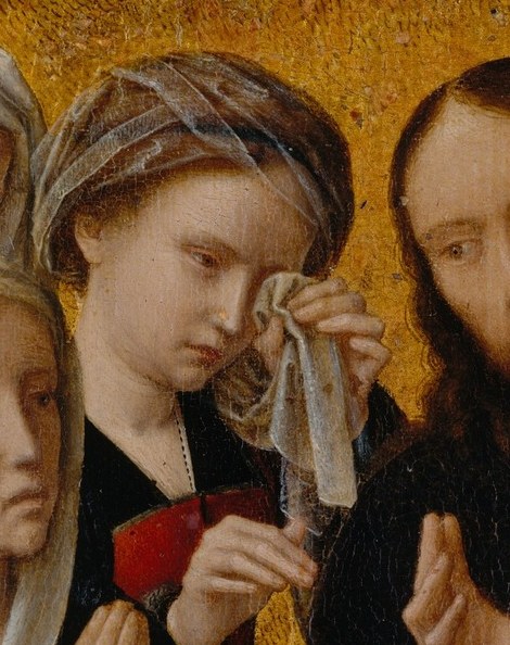 A woman wipes away her tears.