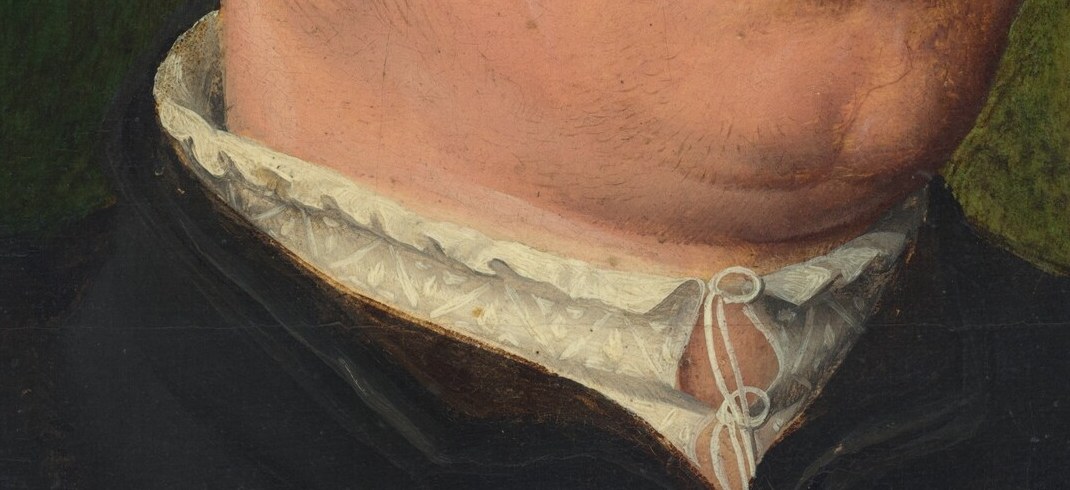 His crisp white collar shows wealth in fine linen.