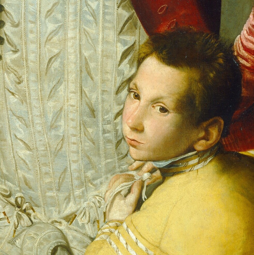 A young page looks up, waiting for an order.