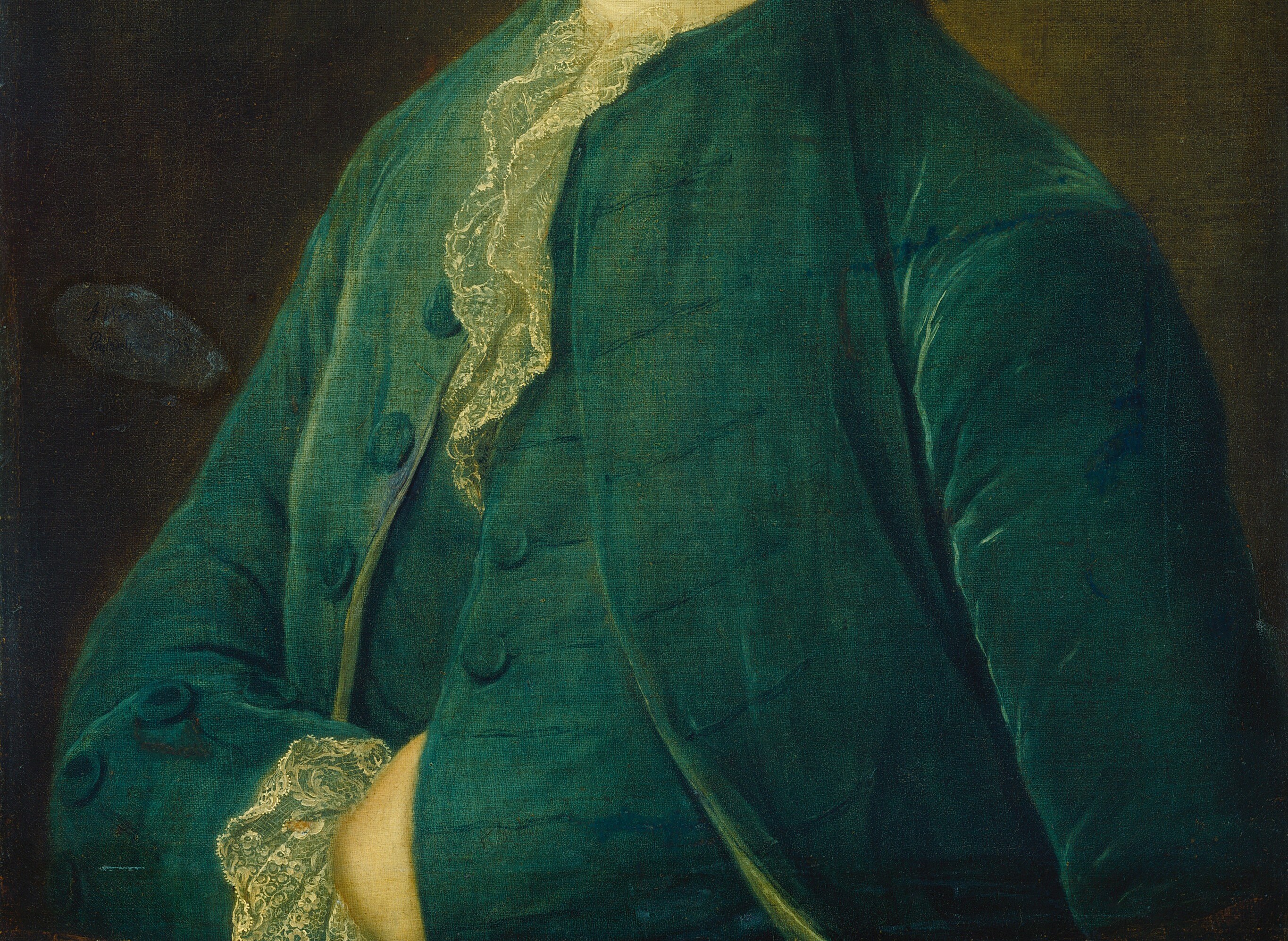 He wears the elegant velvet and lace of his time.
