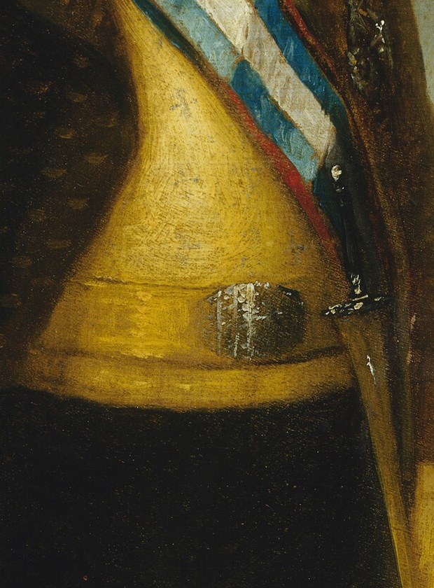 His bright yellow waistcoat draws the eye.