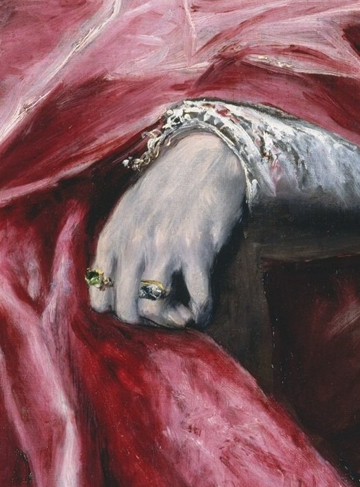 Look closely at the rings on his hands.