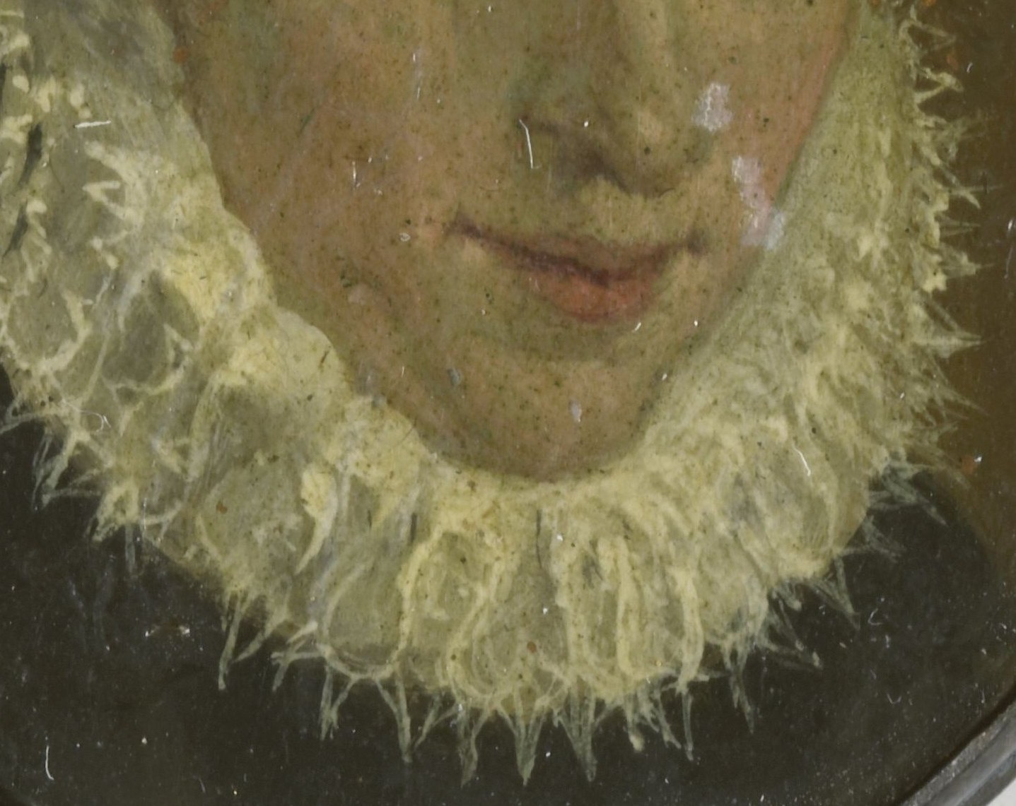 The lady wears a stiff, ruffled collar, fashionable in the 16th century.