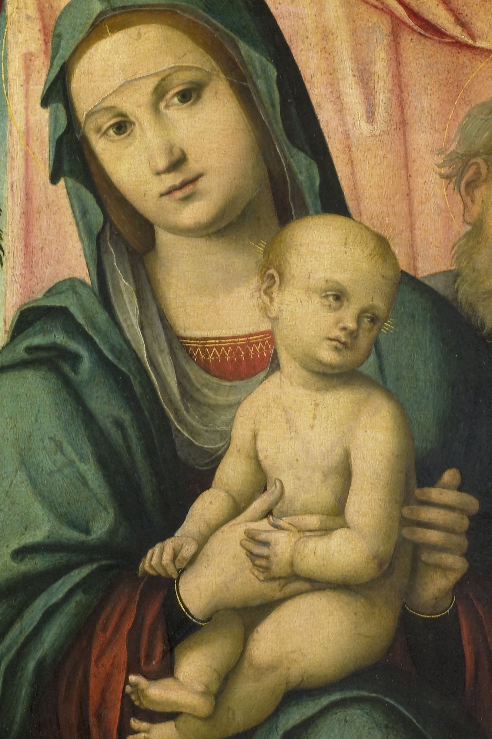 Mary wears a deep green veil, symbolizing hope and new life.