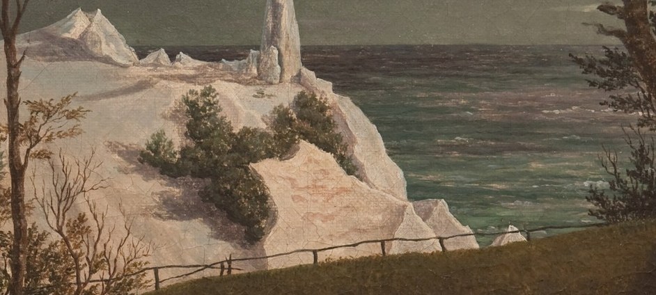 Its luminous white form rises sharply from the dark shoreline.