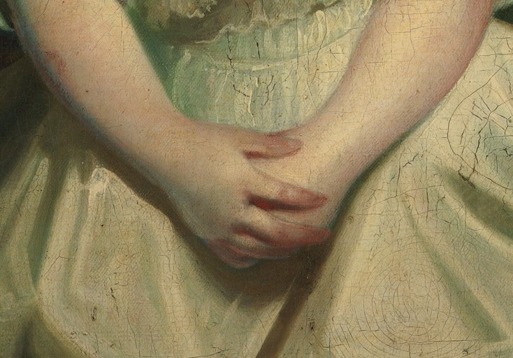 Look at her hands, clasped at the front, the posture of a well-bred child.