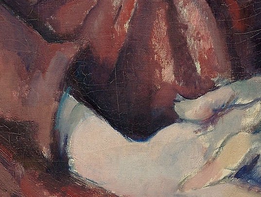 Her hands, clasped in her lap, are a picture of composure.