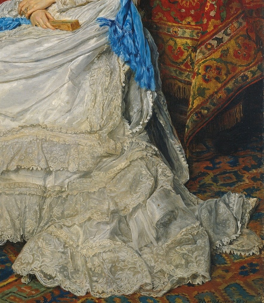 Her gown is an intricate lace.