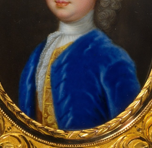 His blue velvet jacket, trimmed with gold, shows his status.