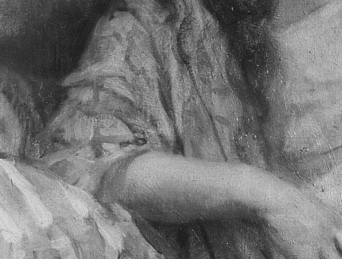 The subtle light on her face highlights her pensive expression.