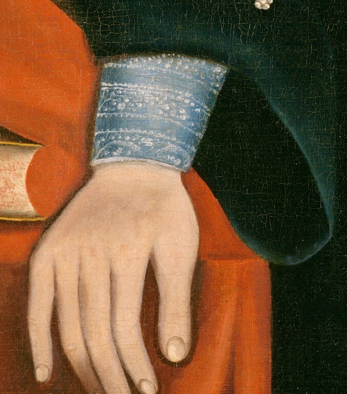 His left hand rests on books, suggesting he was a learned man.