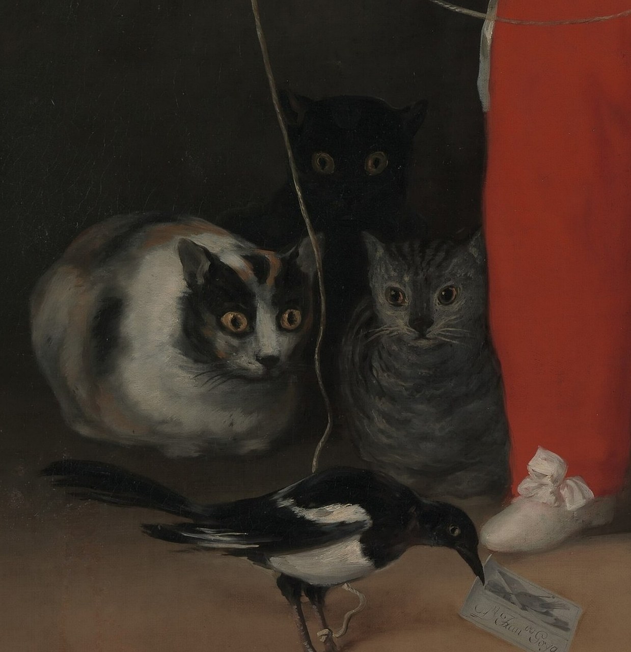 The bird holds what appears to be Goya's own calling card , a rare in-painting signature device and a wink at the artist's presence in the scene