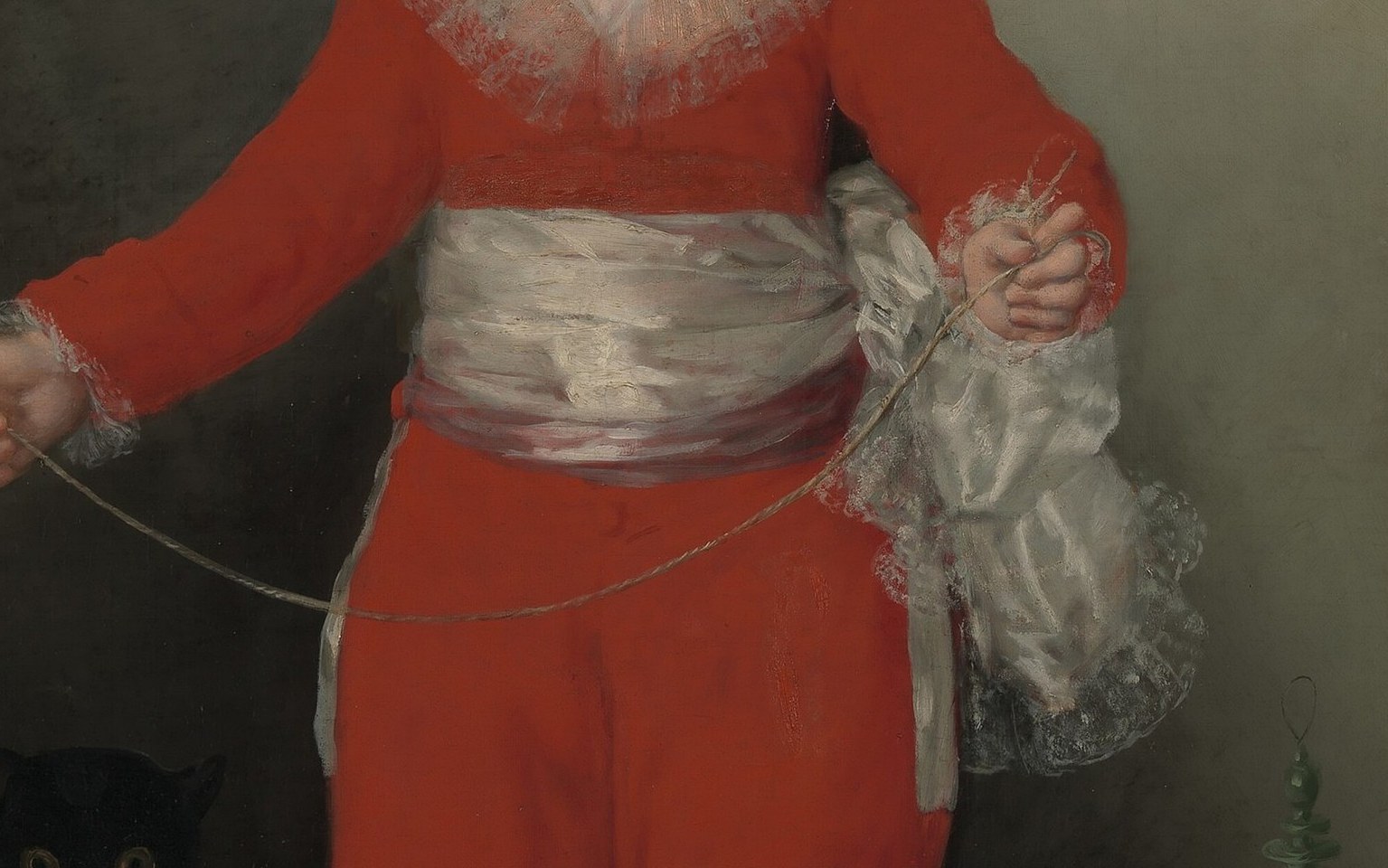A flash of luminous white that breaks the red field; Goya uses it to anchor the eye at center and to connote the purity expected of aristocratic childhood