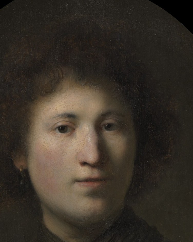 The central subject; Rembrandt lighting makes the face emerge dramatically from surrounding darkness , the portrait's entire psychological weight lives here.