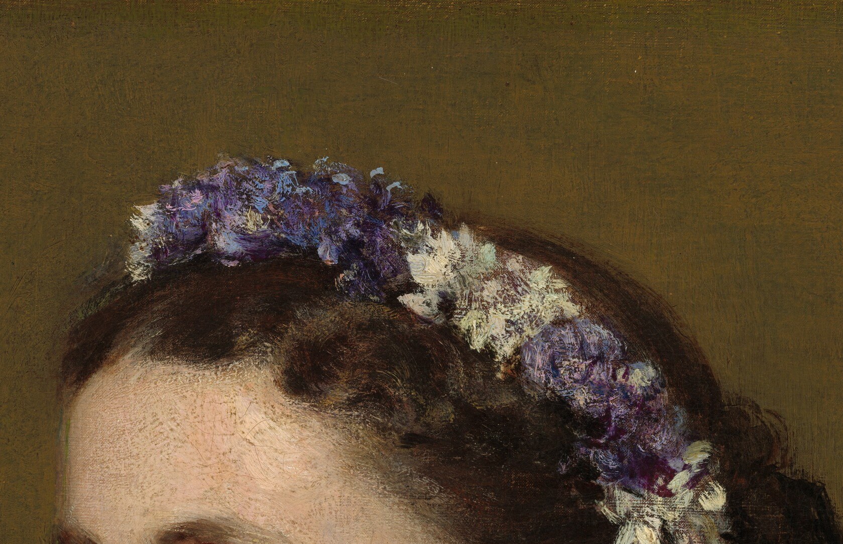 She wears a wreath of purple and white blossoms.
