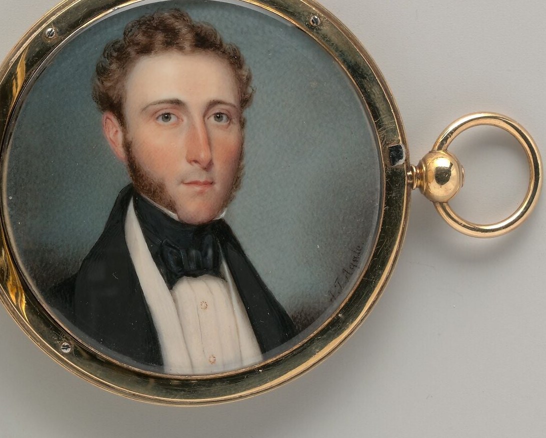 Look closely at the ornate gold frame around the portrait.