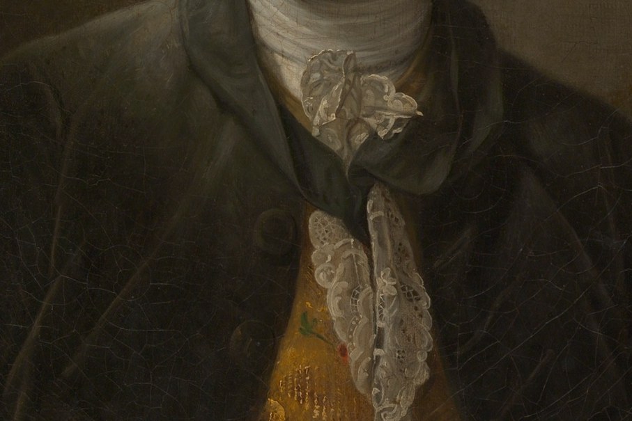 The gold brocade is not vanity. It is a credential.