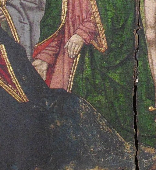 Look closely at the figure kneeling at the cross's base.
