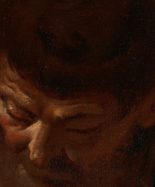 His face is cast downward, lost in thought.