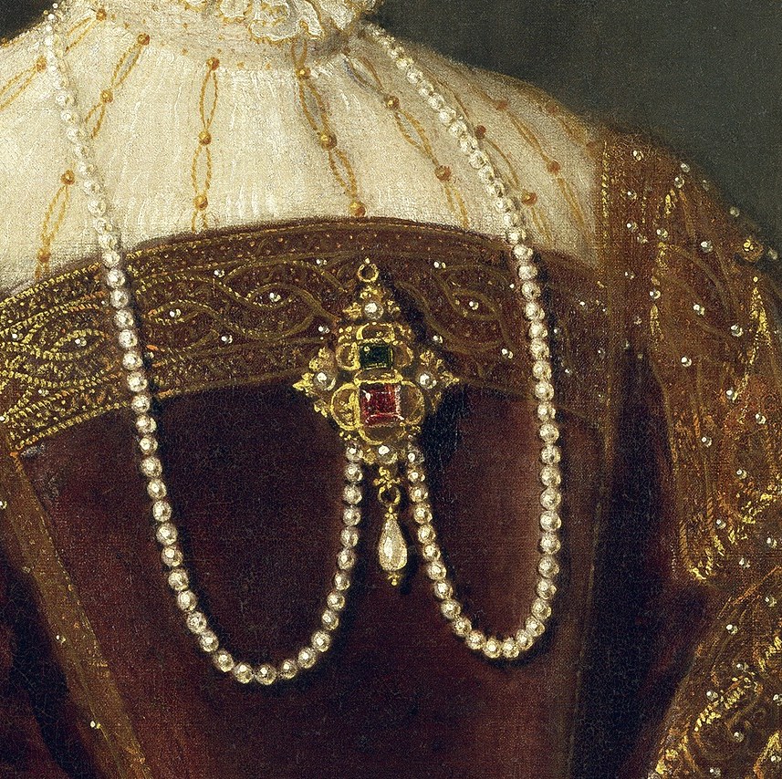 She wears a double strand of pearls, symbolizing purity and wealth.