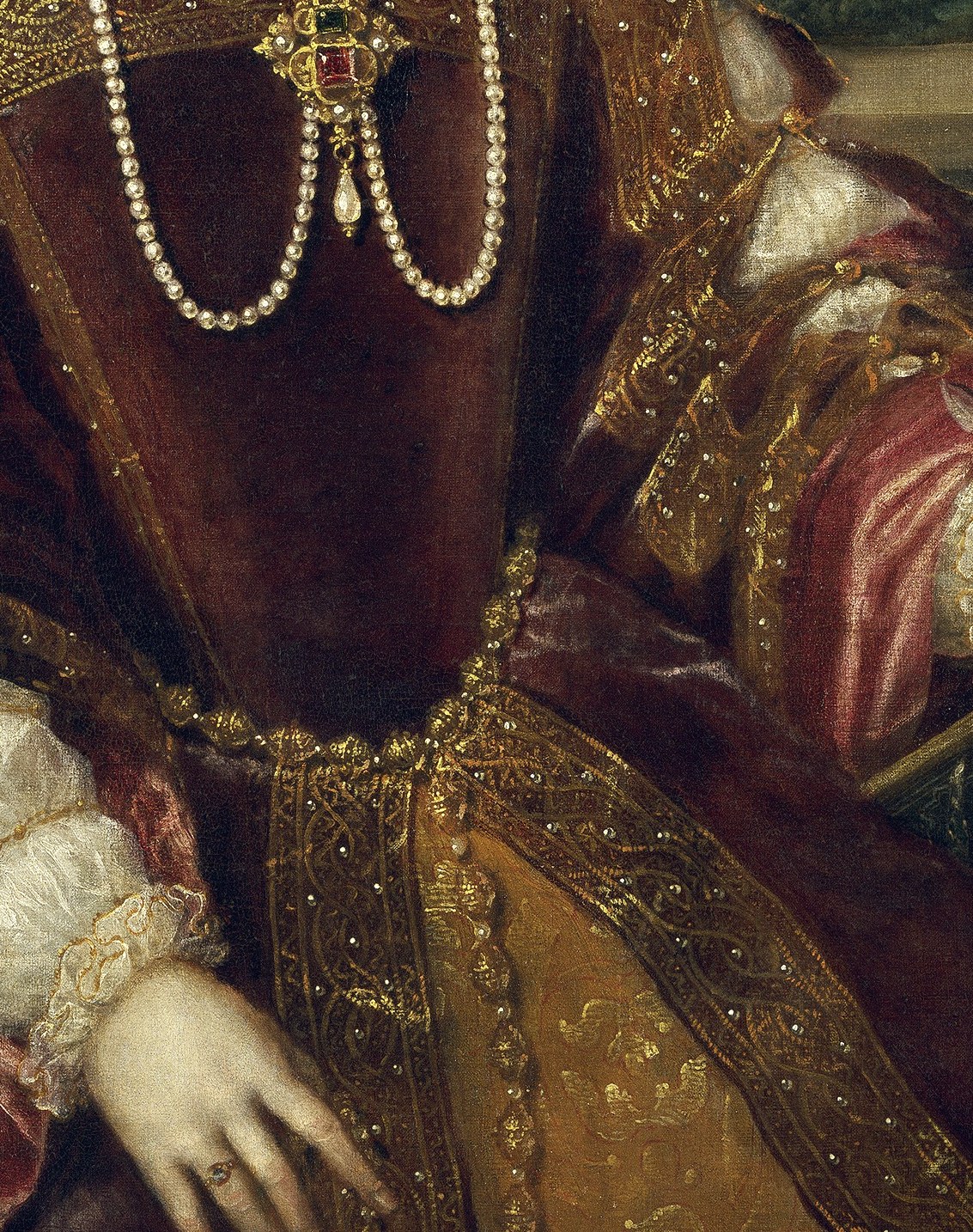 Her regal attire and symbols of authority reinforce her high status.