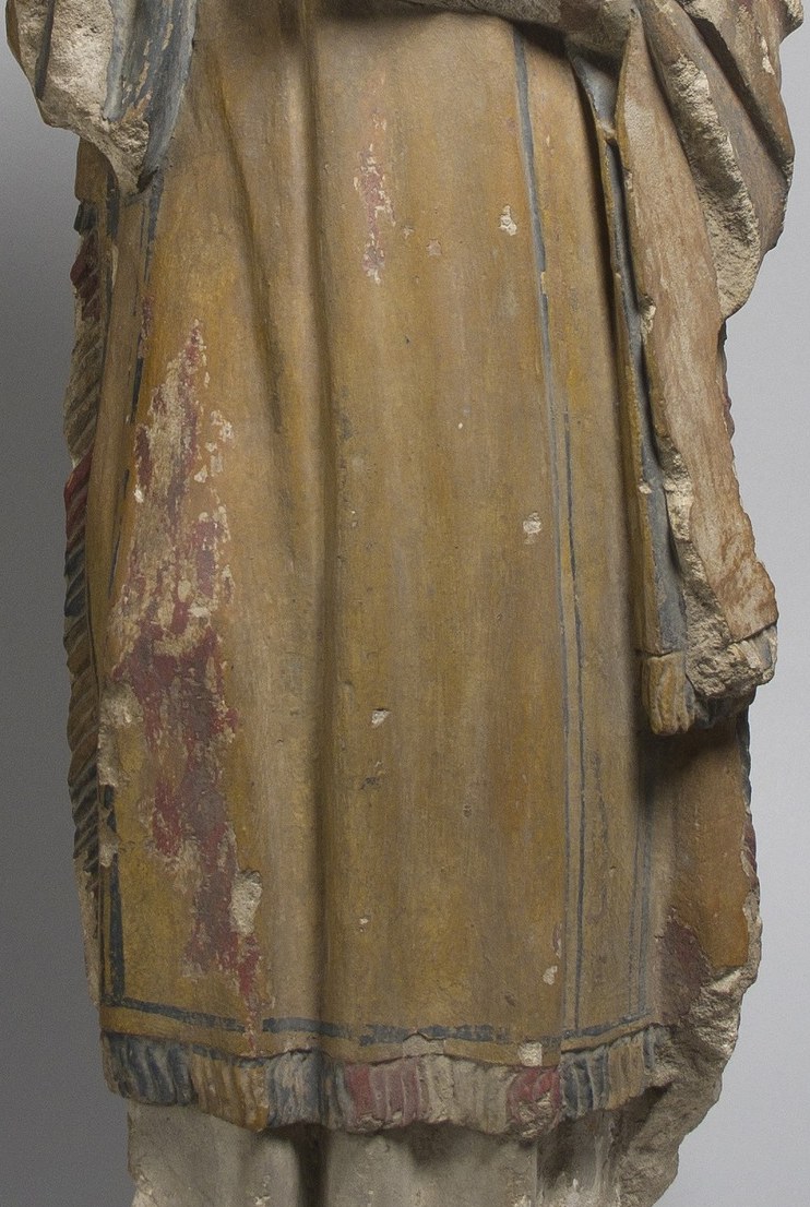 The saint’s robe, simple as it is, shows its age.