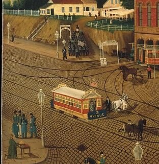 Horses and a railroad share the street. Two technologies, one moment.