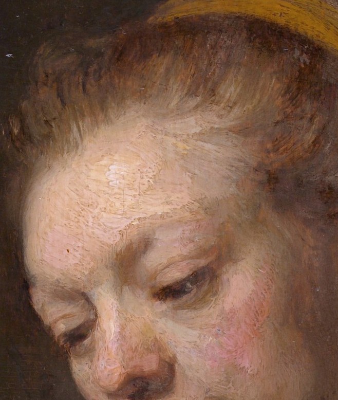 Her face is built from a single warm spotlight against an abyss.