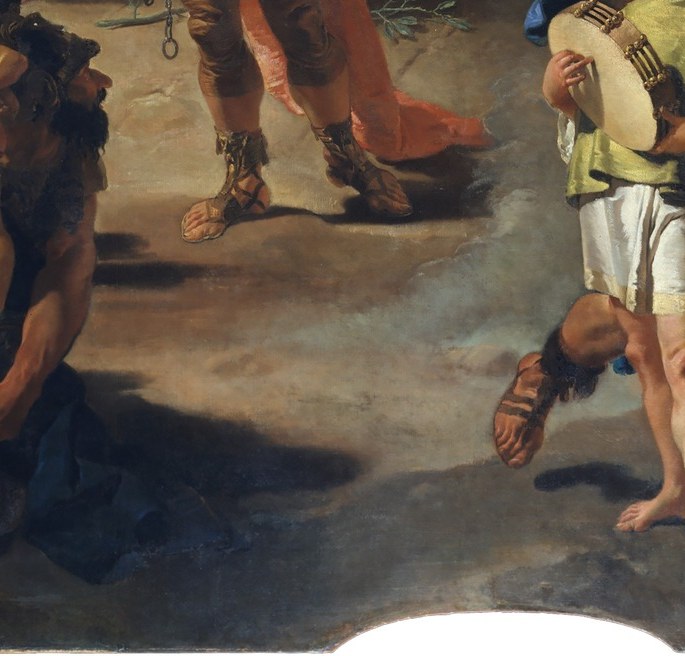 The conquered lie beneath the procession.
