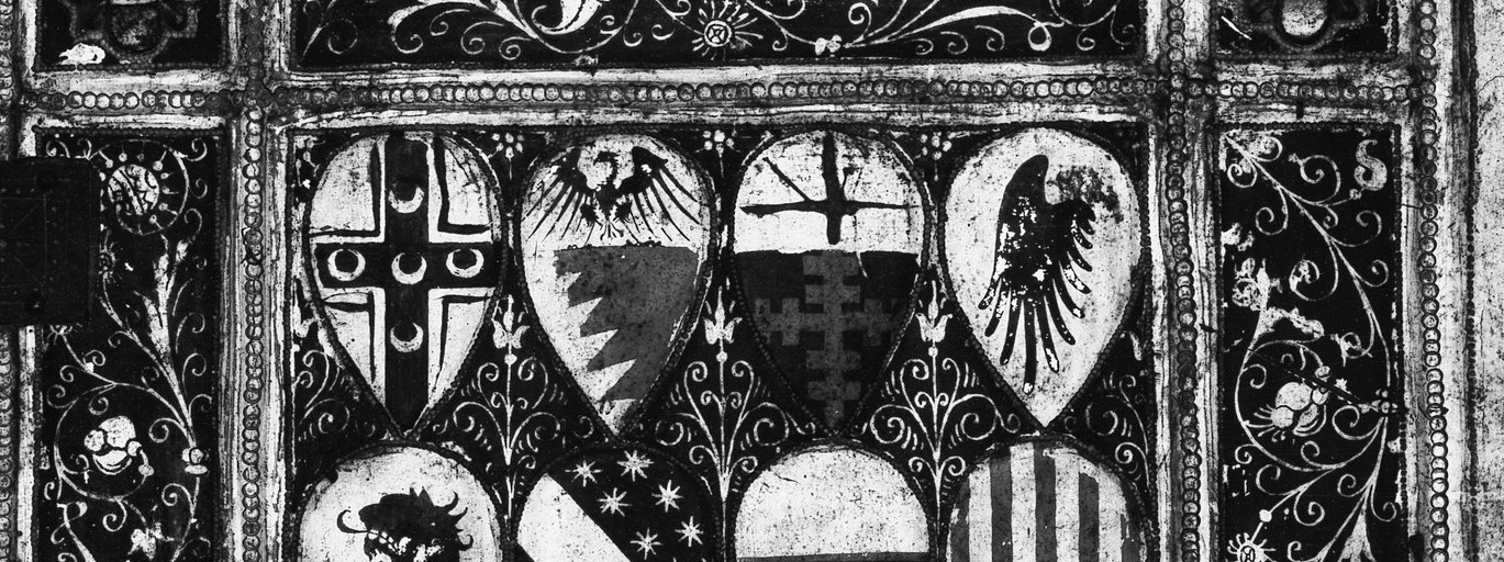 Instead, we see an inventory of heraldic shields.