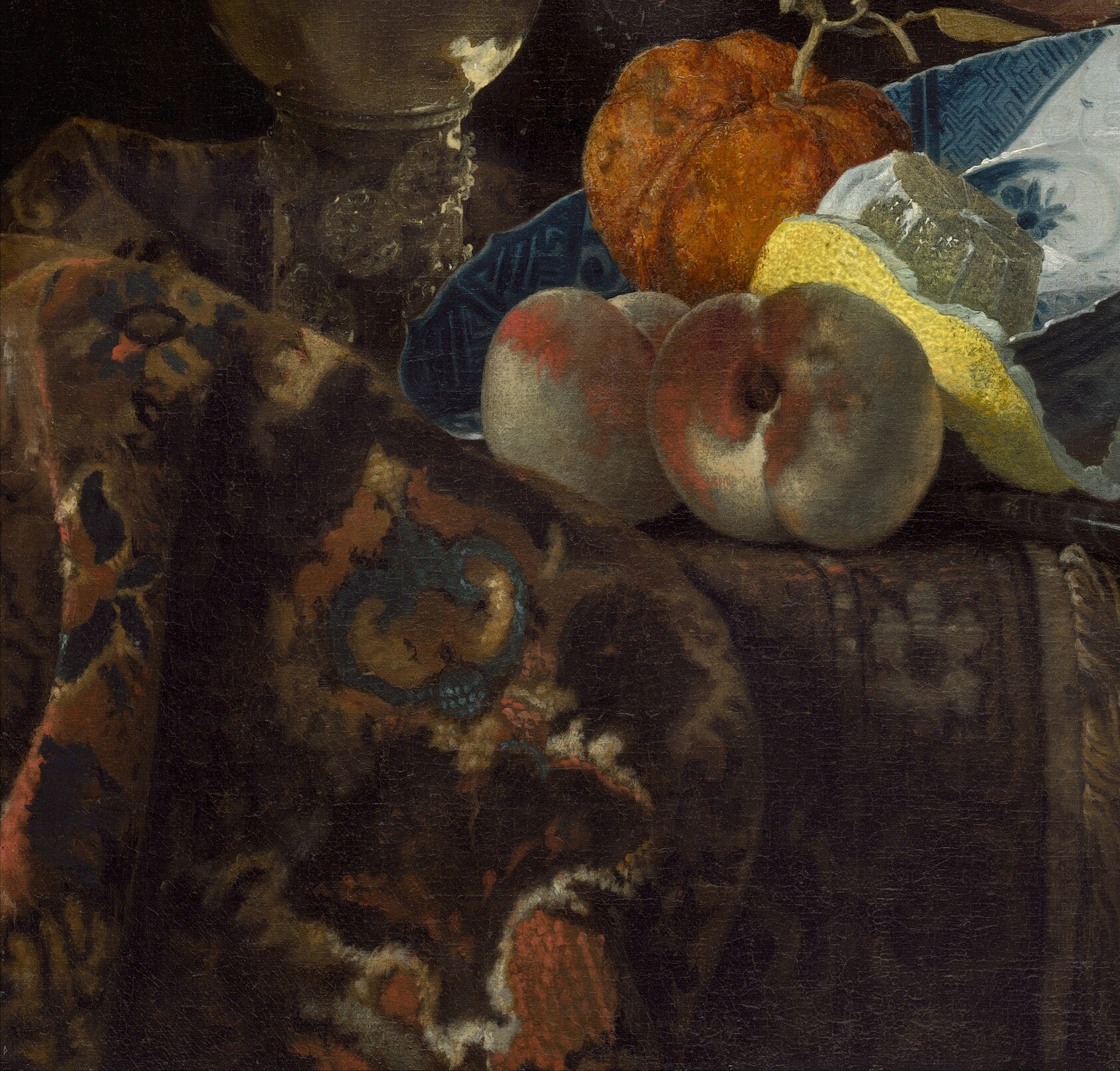 He layered textures: silk, glass, metal, and fruit.