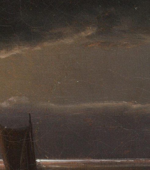 A sailboat is out there, alone on the sea.