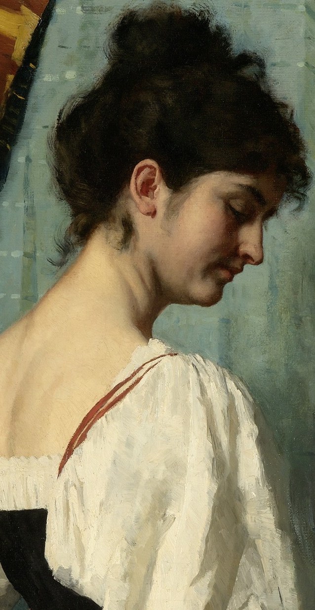 Her gaze is soft, directed downward with affection.