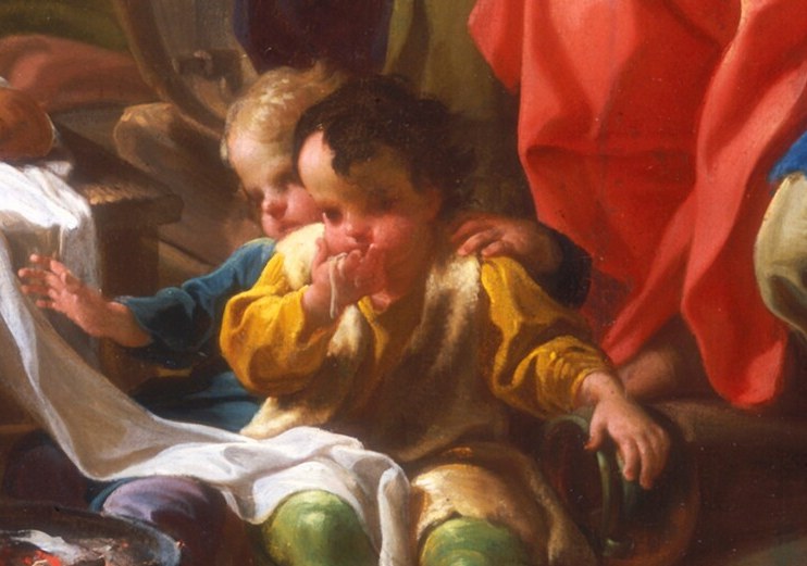 A child eats. Not a grand feast; just food.