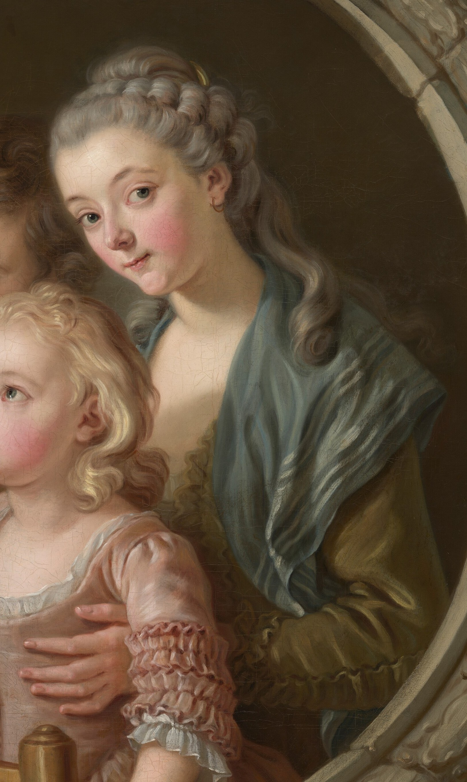 Her mother watches, enjoying her children's curiosity.