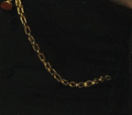 A pocket watch chain subtly shows his professional status.