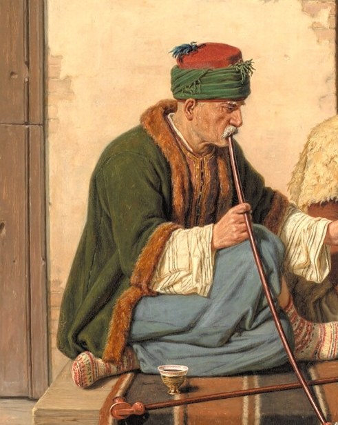 His relaxed posture and the act of smoking suggest a leisurely, social atmosphere.