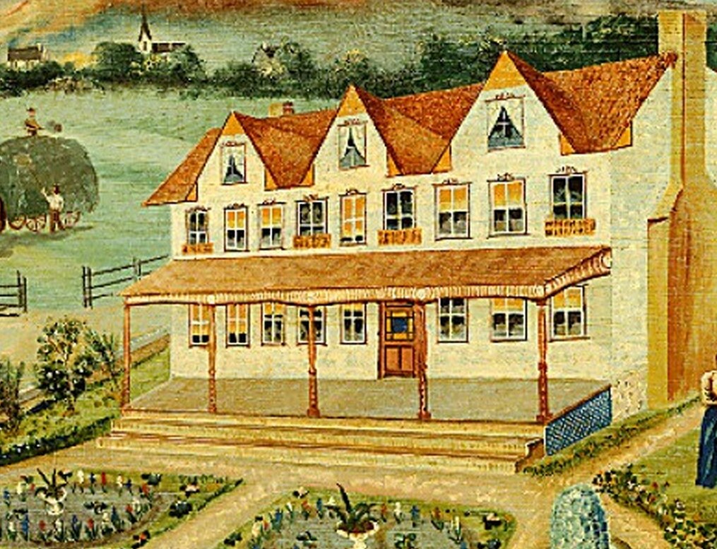 This robust farmhouse, painted white, is the heart of it all.