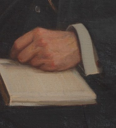 And his hands are carefully posed, holding an open book.