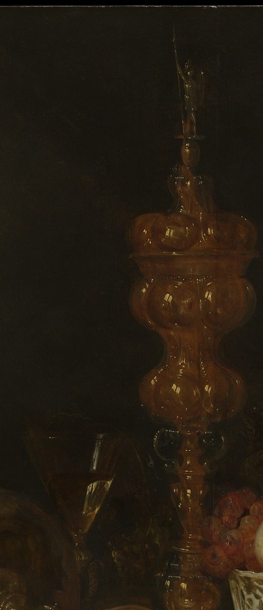 A soaring gold-toned vessel dominates the vertical axis; its hammered and chased surface is a showcase of reflected light and the wealth it represents , probably a silver-gilt or Venetian-style object.