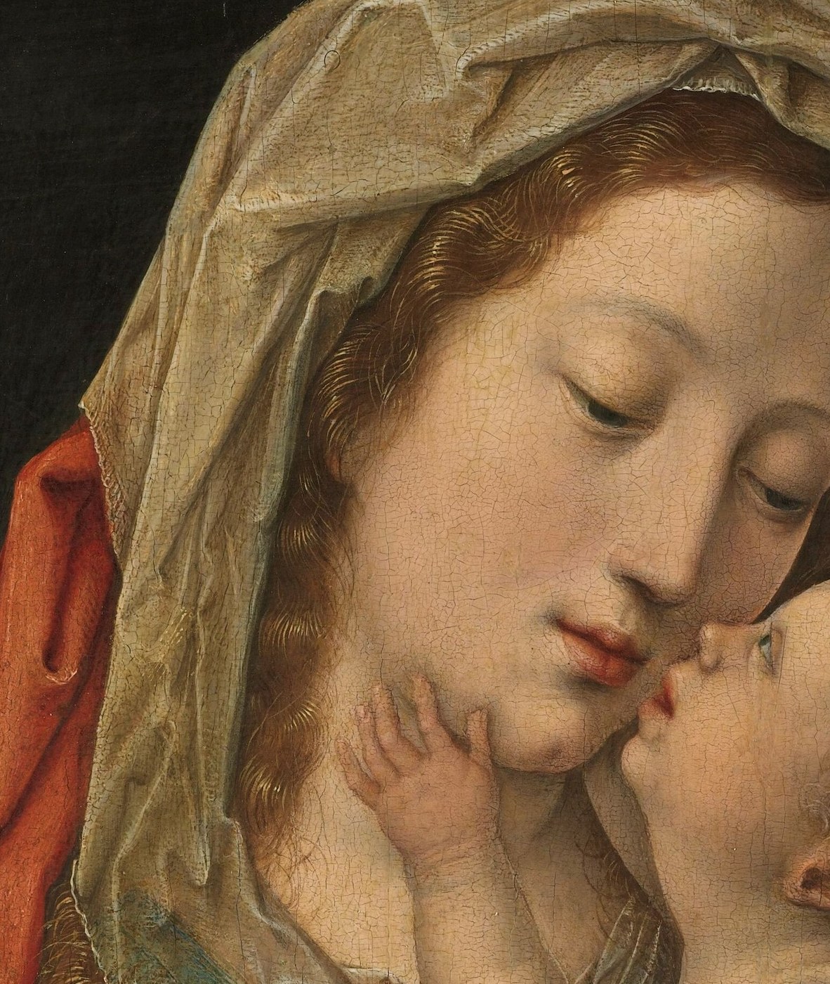 Mary cradles her child, their faces close.