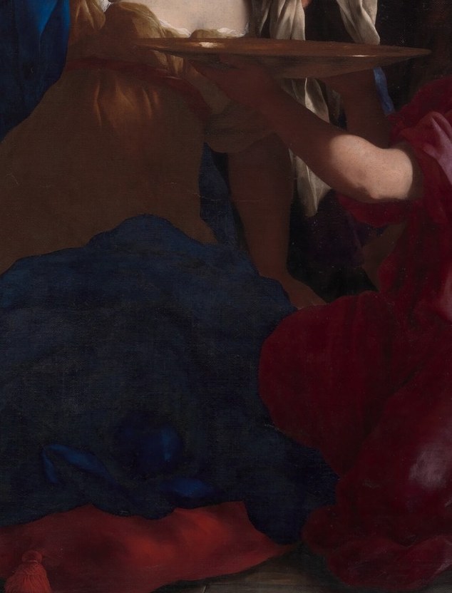 A woman in crimson already grieves where the blood will pool.