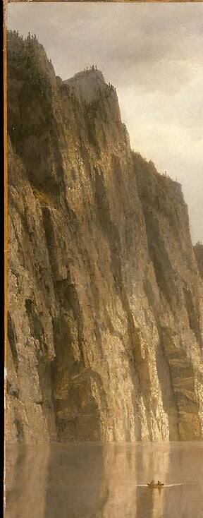 A near-vertical granite slab that drops straight into the river, its reflective grey face contrasting with the warmer foreground , the scale cue that makes the human figures below register as microscopic.