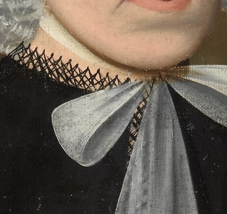 This detail adds a touch of feminine grace and highlights the neckline of her dress.