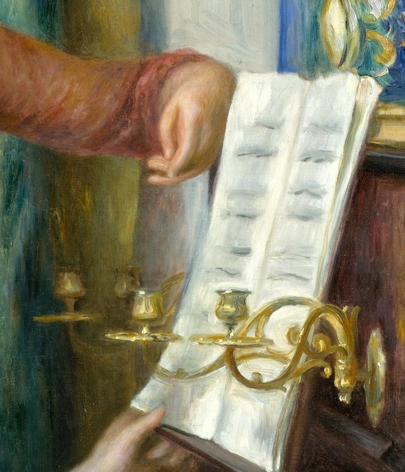 The musical notation is rendered with a soft focus, emphasizing the shared activity rather than the specific piece.