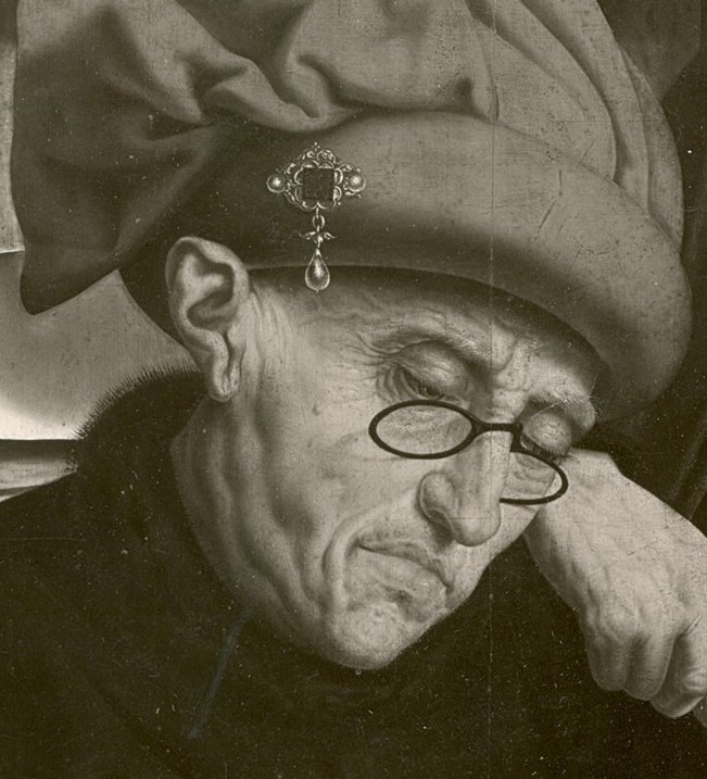 His face shows the weary burden of his profession.