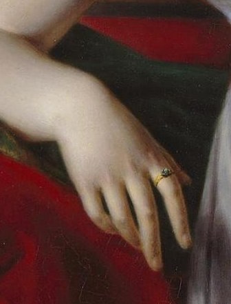 Despite the formality, her left hand rests with a relaxed grip.