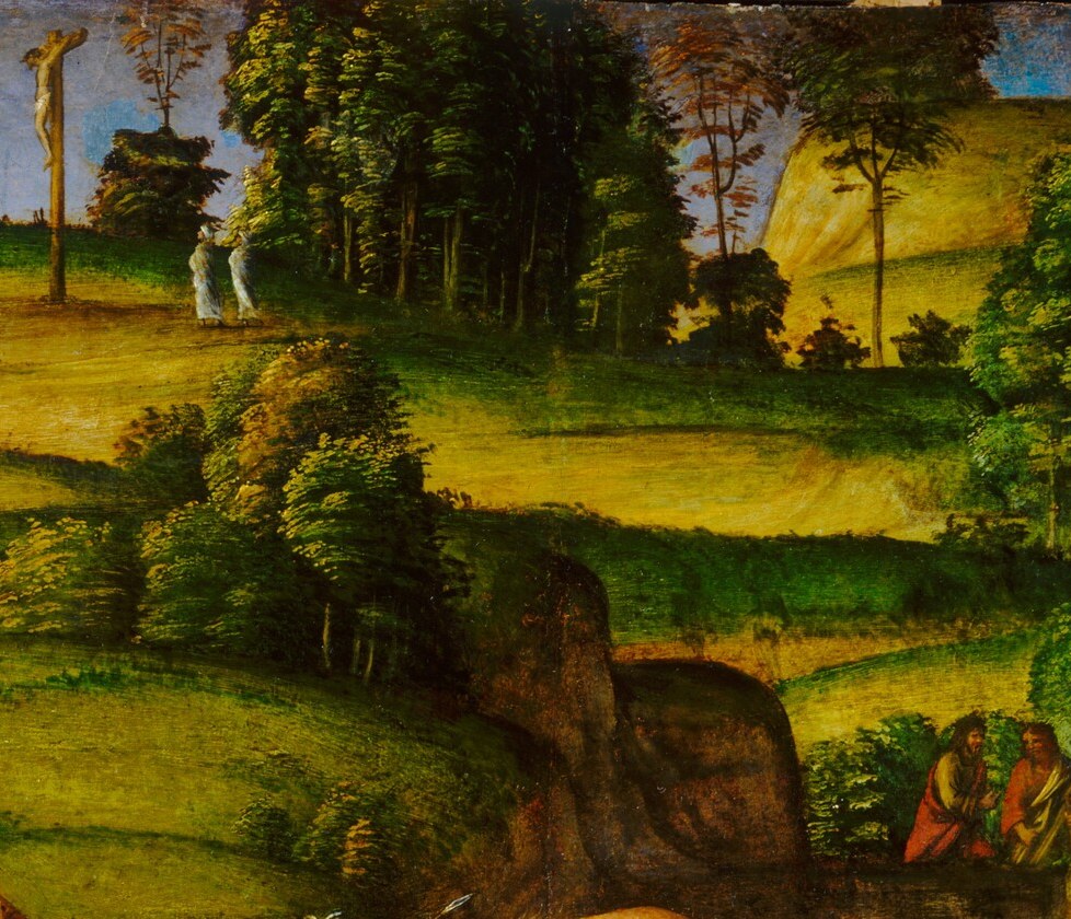 Look just above the mourners, into the green hill.