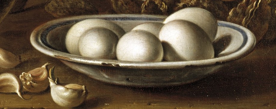 The smooth, rounded forms of the eggs and the delicate blue rim of the bowl create a sense of domestic simplicity.